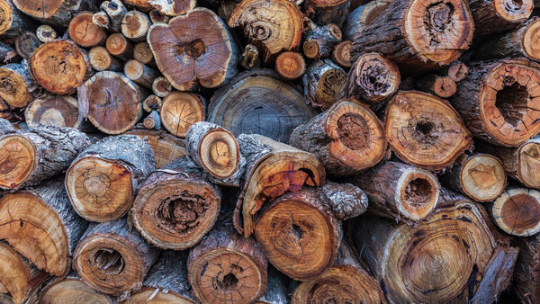 Stacked split firewood logs drying in a woodpile
